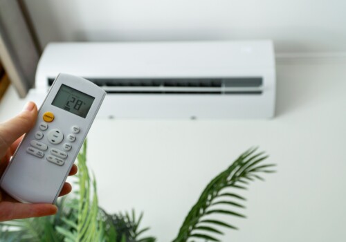 Individual,Adjusting,The,Air,Conditioning,With,A,Remote,Control,For